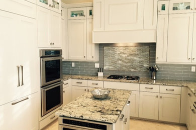 Inspiration for a large contemporary u-shaped travertine floor open concept kitchen remodel in Miami with a single-bowl sink, flat-panel cabinets, white cabinets, granite countertops, stainless steel appliances and an island