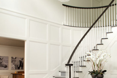 Foyer - large traditional dark wood floor and brown floor foyer idea in New York with white walls