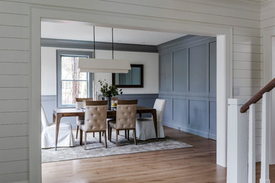 Kitchen/dining room combo - large transitional medium tone wood floor and brown floor kitchen/dining room combo idea in Boston with white walls and no fireplace