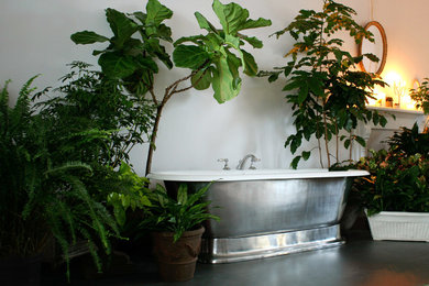 Tropical master bathroom in Nashville with a freestanding tub and slate floors.