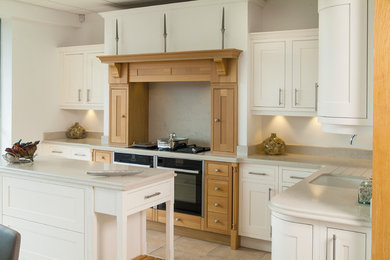 Inspiration for a traditional separate kitchen in Sussex with recessed-panel cabinets and with island.