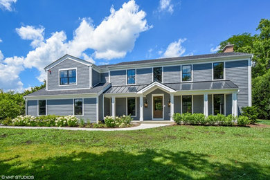 Example of a large classic gray two-story wood gable roof design in Chicago
