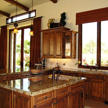 Tuscan Kitchen with Island and Antique Glass in Cabinet Doors