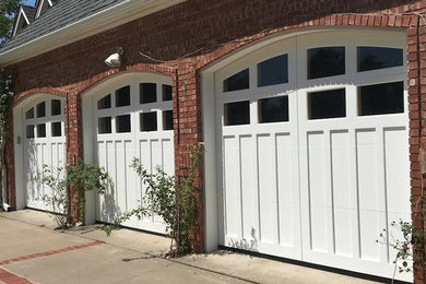 Example of a large classic attached three-car garage design in Oklahoma City