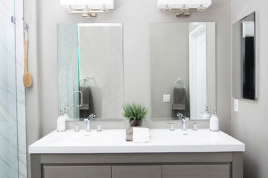 Mid-sized trendy 3/4 gray tile, white tile and stone slab marble floor alcove shower photo in San Diego with flat-panel cabinets, gray cabinets, gray walls, an undermount sink and quartz countertops