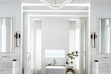 Design ideas for a large contemporary master bathroom in Los Angeles with shaker cabinets, white cabinets, a freestanding tub, an open shower, a wall-mount toilet, white tile, porcelain tile, white walls, medium hardwood floors, an undermount sink, solid surface benchtops, grey floor, an open shower and white benchtops.
