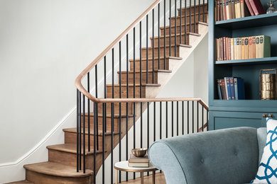 Photo of a large traditional wood straight staircase in London with wood risers.