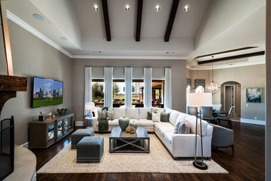 Inspiration for a mid-sized contemporary formal open concept living room in Dallas with beige walls, dark hardwood floors, a corner fireplace, a stone fireplace surround, a wall-mounted tv and brown floor.