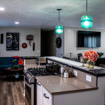 White Kitchen with Blue Tiled Backsplash and Two Tier Island