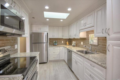 Mid-sized trendy u-shaped porcelain tile and gray floor kitchen pantry photo in San Francisco with white cabinets, granite countertops, a single-bowl sink, raised-panel cabinets, brown backsplash, matchstick tile backsplash, stainless steel appliances, no island and gray countertops