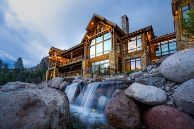 Inspiration for a rustic hillside river rock waterfall in Denver.
