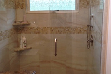 Inspiration for a mid-sized timeless beige tile and porcelain tile porcelain tile and beige floor alcove shower remodel in Orange County with furniture-like cabinets, brown cabinets, beige walls, an undermount sink, granite countertops, a hinged shower door and brown countertops