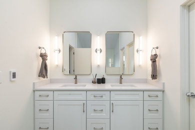 Wet room - large modern master double-sink wet room idea in Seattle with shaker cabinets, white cabinets, quartzite countertops, a hinged shower door and a built-in vanity
