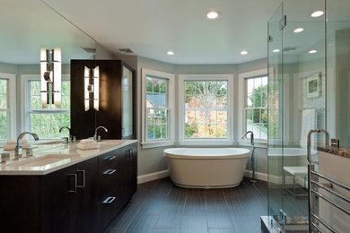 Inspiration for a modern double-sink bathroom remodel in New York with flat-panel cabinets, brown cabinets, a two-piece toilet, an undermount sink and granite countertops