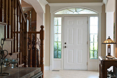 Mid-sized elegant porcelain tile entryway photo in Toronto with white walls and a white front door
