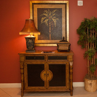 Inspiration för en tropisk hall, med röda väggar och marmorgolv