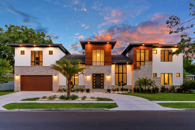 Inspiration for a large modern multicolored two-story mixed siding house exterior remodel in Tampa with a hip roof and a shingle roof