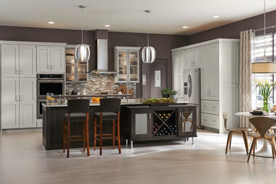 Inspiration for a large transitional l-shaped eat-in kitchen remodel in Other with shaker cabinets, white cabinets and an island