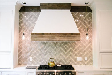 Example of a transitional dark wood floor kitchen design in Atlanta with a farmhouse sink, white cabinets, marble countertops, gray backsplash, ceramic backsplash, stainless steel appliances and two islands