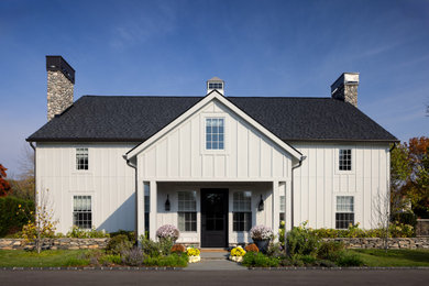 Country white two-story concrete fiberboard and board and batten house exterior idea in Detroit with a shingle roof and a black roof