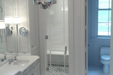 Photo of a master bathroom in New Orleans with marble benchtops, an undermount tub, white tile and marble floors.