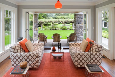 Inspiration for a mid-sized transitional open concept medium tone wood floor and brown floor living room remodel in Cleveland with gray walls, no fireplace and no tv