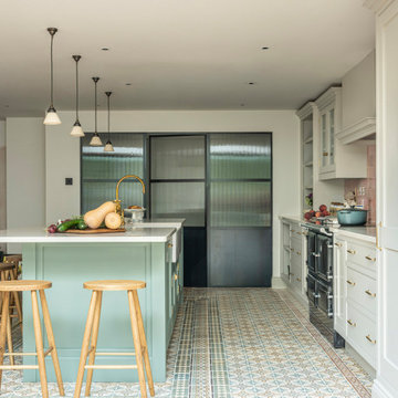 Two tone kitchen cabinets with crittall doors and pantry