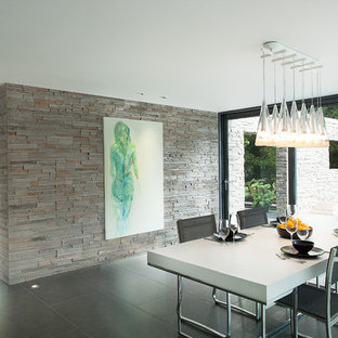 This is an example of a modern dining room in Hampshire with ceramic flooring.