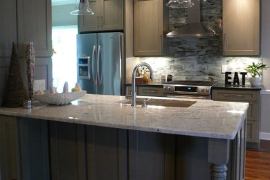Kitchen - transitional medium tone wood floor kitchen idea in Nashville with a single-bowl sink, shaker cabinets, gray cabinets, granite countertops, multicolored backsplash, glass tile backsplash and stainless steel appliances