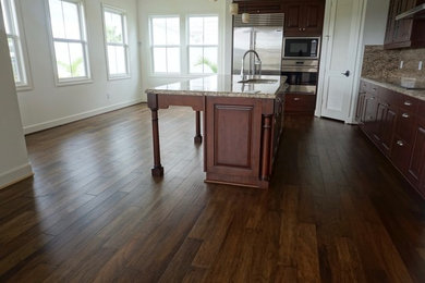 Eat-in kitchen - large contemporary u-shaped dark wood floor and brown floor eat-in kitchen idea in Hawaii with a double-bowl sink, marble countertops, beige backsplash, marble backsplash and an island