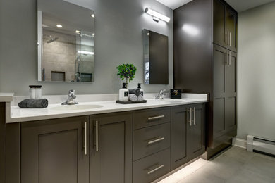 Inspiration for a mid-sized transitional master gray tile and porcelain tile double-sink, porcelain tile and gray floor bathroom remodel in Chicago with white countertops, shaker cabinets, brown cabinets, gray walls, an integrated sink, quartz countertops, a hinged shower door and a built-in vanity