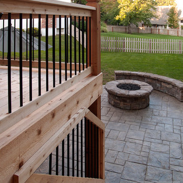 Leeder - Cedar deck in Kansas City with stamped concrete patio and firepit.