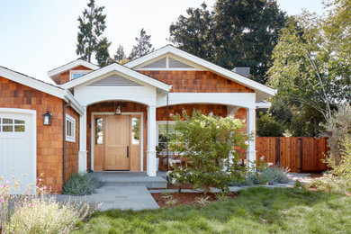 Inspiration for a large transitional one-story wood and shingle exterior home remodel in San Francisco with a shingle roof and a black roof
