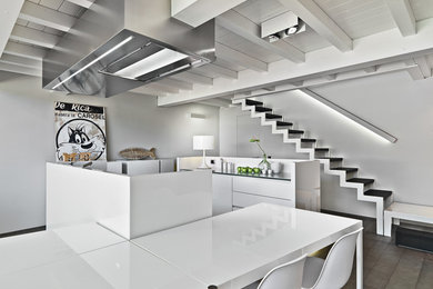 Photo of a contemporary galley eat-in kitchen in Milan with flat-panel cabinets, white cabinets, white splashback and multiple islands.