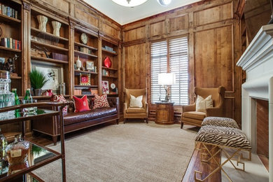 Inspiration for a large traditional study room in Dallas with brown walls, medium hardwood floors, a standard fireplace, a stone fireplace surround and brown floor.
