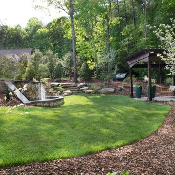 Backyard landscape with water spilling over from the infinity pool.