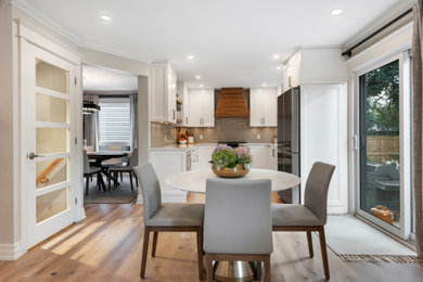 Example of a mid-sized transitional light wood floor and beige floor kitchen/dining room combo design in Ottawa with beige walls