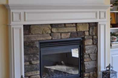 Inspiration for a family room in Seattle with a standard fireplace and a stone fireplace surround.