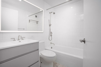 Small minimalist master ceramic tile and single-sink shower curtain photo in New York with white cabinets, white walls, an undermount sink, quartzite countertops and a floating vanity