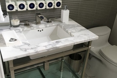 Bathroom - mid-sized contemporary 3/4 gray tile and glass tile mosaic tile floor and gray floor bathroom idea in New York with a one-piece toilet, gray walls, an undermount sink and marble countertops