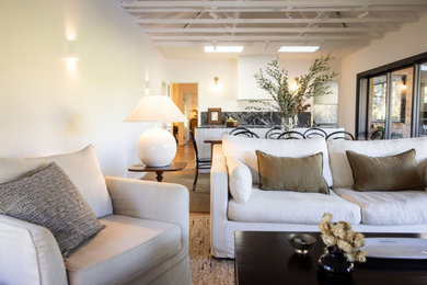 This is an example of a large modern living room in Wollongong with white walls, dark hardwood floors, brown floor and exposed beam.