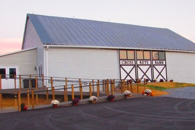 Large rustic gray two-story vinyl gable roof idea in Other
