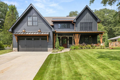 Mid-sized cottage black two-story mixed siding and board and batten exterior home photo in Atlanta with a shingle roof and a brown roof