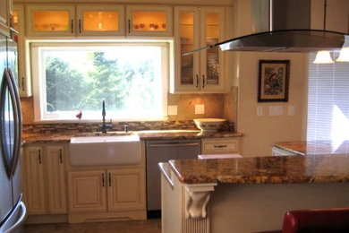 Small traditional l-shaped eat-in kitchen in Seattle with a farmhouse sink, raised-panel cabinets, white cabinets, granite benchtops, yellow splashback, glass tile splashback, stainless steel appliances, porcelain floors and with island.