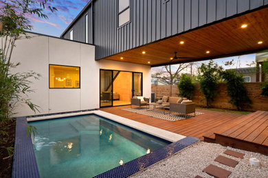 Trendy backyard tile and rectangular pool photo in Austin