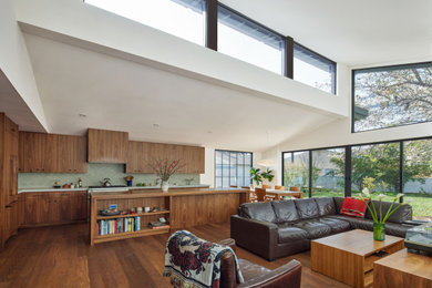 Family room - mid-sized 1950s open concept medium tone wood floor, brown floor and vaulted ceiling family room idea in Los Angeles with white walls, no fireplace and a wall-mounted tv
