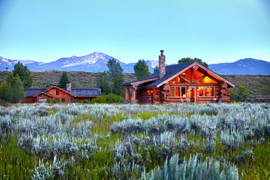 Mid-sized mountain style brown one-story wood exterior home photo with a shingle roof