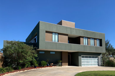 Mid-sized modern green two-story mixed siding flat roof idea