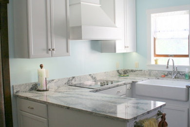 Kitchen - small country u-shaped dark wood floor kitchen idea in Other with a farmhouse sink, recessed-panel cabinets, white cabinets, quartz countertops and stainless steel appliances