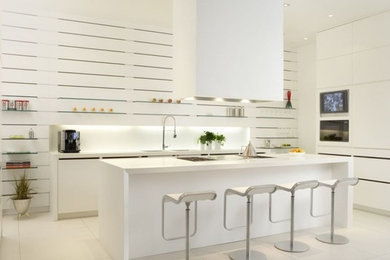 Inspiration for a large modern eat-in kitchen remodel in Toronto with solid surface countertops, white cabinets, white backsplash and an island